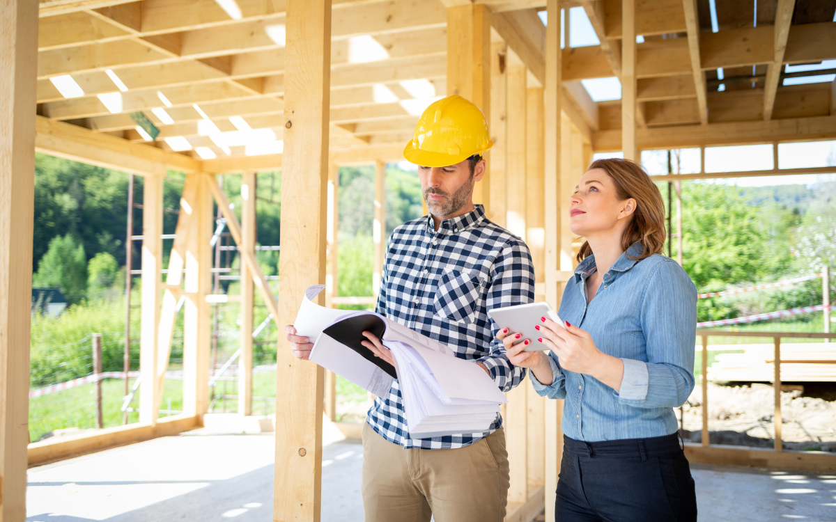 Two real estate insurance brokers discussing liability insurance solutions for property protection and risk management